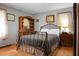 Bright bedroom with a full bed, hardwood floors, and matching nightstand at 4428 Maple Ridge Rd, Walterboro, SC 29488