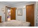 Comfortable bedroom showing multiple doorframes and hardwood floors at 4428 Maple Ridge Rd, Walterboro, SC 29488