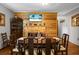 Dining room featuring a wood dining table, and fireplace and wood-clad wall at 4428 Maple Ridge Rd, Walterboro, SC 29488