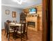 Elegant dining room with rustic wood wall and fireplace and large wood dining table at 4428 Maple Ridge Rd, Walterboro, SC 29488