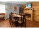 Elegant dining room featuring a wood table and chairs and a fireplace and wood-clad wall at 4428 Maple Ridge Rd, Walterboro, SC 29488