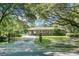 Charming brick home with lush front lawn, mature trees, and gated driveway at 4428 Maple Ridge Rd, Walterboro, SC 29488