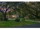 Charming brick home with lush front lawn, mature trees, and gated driveway at 4428 Maple Ridge Rd, Walterboro, SC 29488