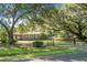 Charming brick home with lush front lawn, mature trees, and gated driveway at 4428 Maple Ridge Rd, Walterboro, SC 29488