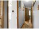 Hallway with access to a bathroom and other rooms, showcasing paneling and flooring at 4428 Maple Ridge Rd, Walterboro, SC 29488