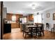 A combination kitchen and dining area featuring hardwood floors, a ceiling fan, and neutral wall colors at 4428 Maple Ridge Rd, Walterboro, SC 29488