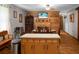 Open kitchen with wood trim, an island, and a decorative beach themed wall decoration at 4428 Maple Ridge Rd, Walterboro, SC 29488