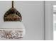 Decorative light fixture with floral detail mounted on a white wall near a window at 4428 Maple Ridge Rd, Walterboro, SC 29488