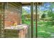 Outdoor kitchen sink area looking out to the backyard, blending indoor convenience with nature's tranquility at 4428 Maple Ridge Rd, Walterboro, SC 29488