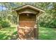 Outdoor kitchen with brick accents, nestled in a lush, green yard, blending convenience with nature's beauty at 4428 Maple Ridge Rd, Walterboro, SC 29488