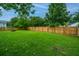 Expansive backyard enclosed by a wooden fence, offering a private outdoor space with mature trees at 468 Maple Oak Ln, Charleston, SC 29414