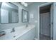 Well-lit bathroom with dual sinks, modern fixtures, and a framed mirror at 468 Maple Oak Ln, Charleston, SC 29414