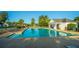 Community swimming pool with lounge chairs, surrounded by lush landscaping, offering a relaxing environment at 468 Maple Oak Ln, Charleston, SC 29414
