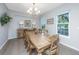 Dining room features hardwood floors, natural light, and a rustic dining table with seating for six at 468 Maple Oak Ln, Charleston, SC 29414