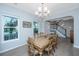 Well-lit dining area showcasing hardwood floors, a rustic table with seating, and neutral wall colors at 468 Maple Oak Ln, Charleston, SC 29414