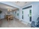 Open concept dining room with hardwood floors, chandelier, and view of the front yard at 468 Maple Oak Ln, Charleston, SC 29414