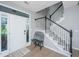 Bright foyer featuring hardwood floors, a staircase with dark wood accents, and a bench at 468 Maple Oak Ln, Charleston, SC 29414