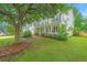 Well-maintained two-story home featuring a covered porch, attached garage, and mature landscaping at 468 Maple Oak Ln, Charleston, SC 29414