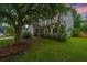 Charming two-story home with a covered front porch, mature trees, and well-maintained landscaping at 468 Maple Oak Ln, Charleston, SC 29414