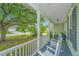 Inviting front porch with rocking chairs, perfect for enjoying the peaceful neighborhood views at 468 Maple Oak Ln, Charleston, SC 29414
