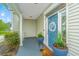 Inviting front porch with a blue door, stylish planters, and a cozy, welcoming ambiance at 468 Maple Oak Ln, Charleston, SC 29414