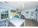Bright home office with a large desk, built-in shelving, and a comfortable seating area at 468 Maple Oak Ln, Charleston, SC 29414