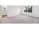 Bright bedroom with a walk-in closet, neutral carpeting, white walls, and a view of the neighborhood at 493 Colchester Court Ct, Moncks Corner, SC 29461