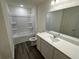Clean bathroom featuring tub/shower combo, vanity with mirror, and wood-look flooring at 495 Colchester Ct, Moncks Corner, SC 29461