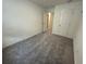 Bright bedroom featuring neutral carpet, fresh white walls, and interior door access at 495 Colchester Ct, Moncks Corner, SC 29461