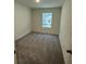 Cozy bedroom with soft neutral carpet, white walls, and a sunny window view at 495 Colchester Ct, Moncks Corner, SC 29461