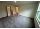 Spacious bedroom with neutral carpet, window, and convenient interior door access at 495 Colchester Ct, Moncks Corner, SC 29461