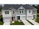 New townhomes featuring varied siding, dark roofing, attached garages, and manicured lawns at 495 Colchester Ct, Moncks Corner, SC 29461