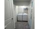 Convenient laundry room with washer, dryer, storage shelves, and dual doors at 495 Colchester Ct, Moncks Corner, SC 29461