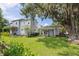 Spacious backyard with lush lawn, mature trees, and a charming guest house at 5017 W Liberty Park Cir, North Charleston, SC 29405