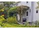 Landscaped backyard with an outdoor lounge area covered in climbing vines at 5017 W Liberty Park Cir, North Charleston, SC 29405