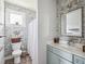 Charming bathroom featuring floral wallpaper, natural light, and a classic vanity at 5017 W Liberty Park Cir, North Charleston, SC 29405