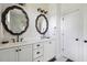 Bathroom showcasing double vanity, decorative mirrors, geometric wallpaper, and modern fixtures at 5017 W Liberty Park Cir, North Charleston, SC 29405