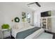 Bright bedroom with white walls, ceiling fan, large windows, and modern decor at 5017 W Liberty Park Cir, North Charleston, SC 29405