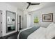Well-lit bedroom with large mirror, white walls, dark floors, and serene, natural accents at 5017 W Liberty Park Cir, North Charleston, SC 29405