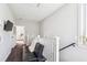 Hallway includes seating and railing with a view into the bedroom at 5017 W Liberty Park Cir, North Charleston, SC 29405