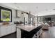Open kitchen and living area with modern stainless steel appliances and large island at 5017 W Liberty Park Cir, North Charleston, SC 29405