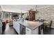 Open-concept kitchen with a large island, modern appliances, and stylish black-and-white wallpaper at 5017 W Liberty Park Cir, North Charleston, SC 29405