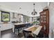 Open kitchen and dining area with large island, modern lighting, and dining table at 5017 W Liberty Park Cir, North Charleston, SC 29405