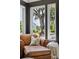 Cozy living room chair with a scenic outdoor view, enhanced by natural light streaming through the windows at 5017 W Liberty Park Cir, North Charleston, SC 29405