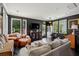 Spacious living room with dark walls, hardwood floors, large windows, and cozy seating, perfect for relaxation and entertaining at 5017 W Liberty Park Cir, North Charleston, SC 29405