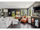 The open-concept living area features hardwood floors, dark walls, and stylish sofas and furniture pieces at 5017 W Liberty Park Cir, North Charleston, SC 29405