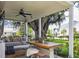 Relaxing outdoor patio area with a dining table, swing, and views of a massive, moss-covered tree at 5017 W Liberty Park Cir, North Charleston, SC 29405