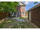 A beautiful backyard with a small patio, complemented by lush greenery and privacy fence at 5110 Hyde Park Village Ln, North Charleston, SC 29405