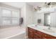 Bright bathroom featuring dual sinks and vanity with a separate tub at 5110 Hyde Park Village Ln, North Charleston, SC 29405