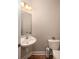Half bathroom featuring a pedestal sink and toilet with hardwood floors at 5110 Hyde Park Village Ln, North Charleston, SC 29405